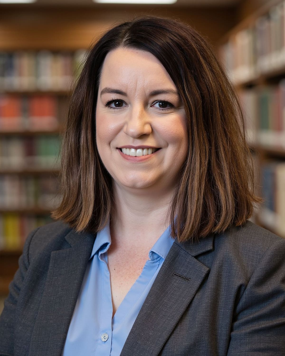 Molly Hinke-DeWild, LISW, in front of a bookcase