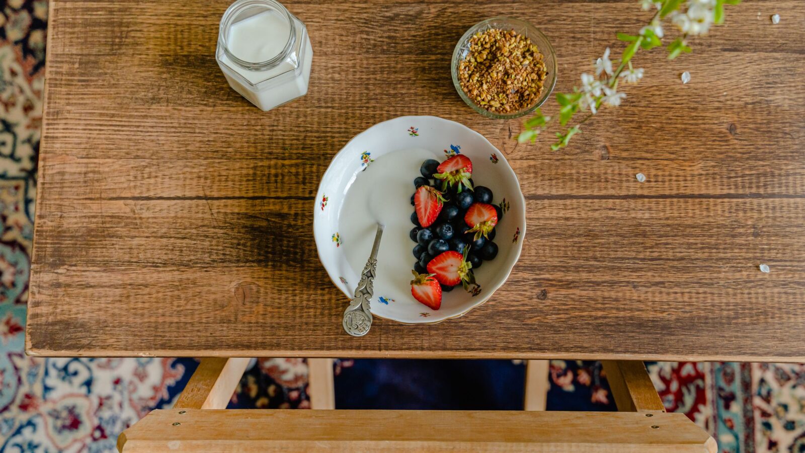 A bowl of yogurt and berries on a wooden table